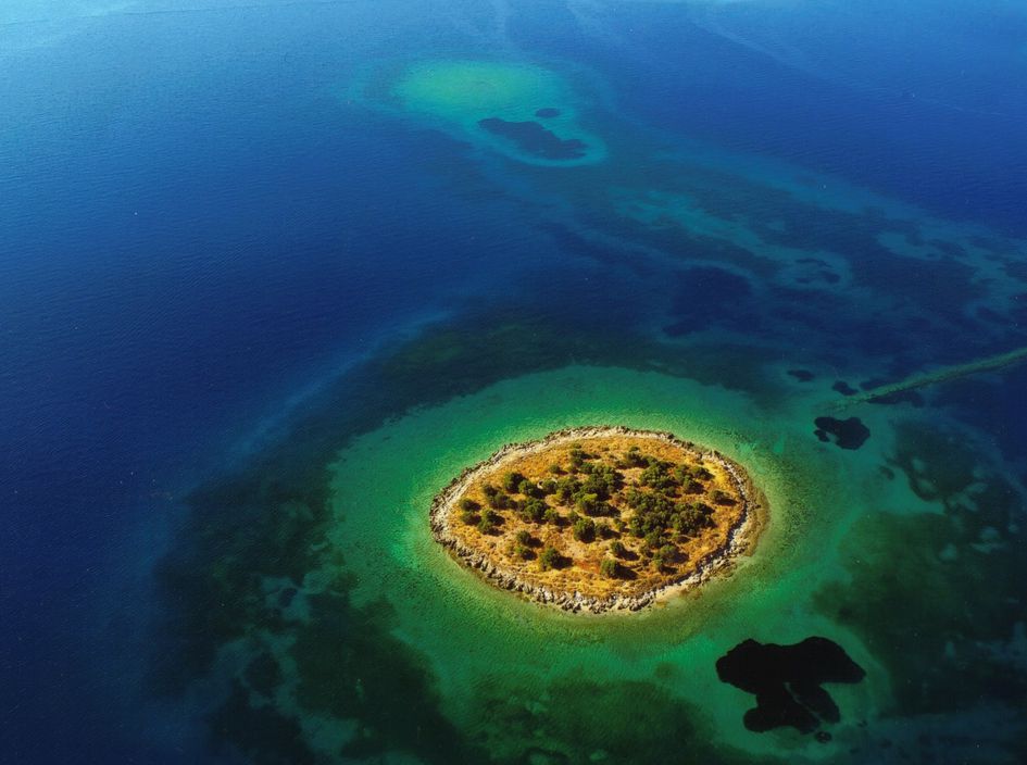 St Athanasios Island. Cost: $1,857,215. Size: 2.5 Acres. Pros: "Pine and olive trees are scattered all over the ground...small sandy beach is located on the northwestern region of the island." Also, LOOK AT THAT PICTURE. Cons: SHUT UP & LOOK AT THAT PICTURE.